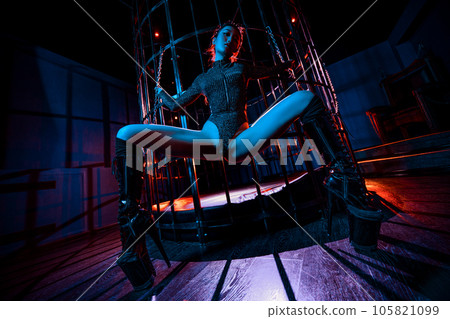 Young asian woman posing near cage bdsm style portrait 105821099