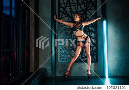 Young woman dancer in lingerie posing on wall background 105821101