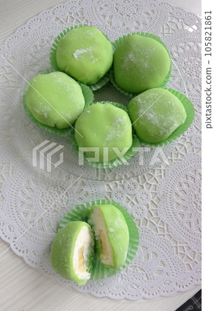 DIY mochi. Japanese sweet in the form of a kolobok or cake made from rice dough. Light green, taken from above. 105821861