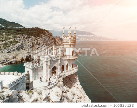 Crimea Swallow's Nest Castle on the rock over the Black Sea. It is a tourist attraction of Crimea. Amazing aerial view of the Crimea coast with the castle above abyss on sunny day. 105823128