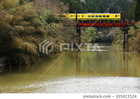 A yellow diesel car crossing a red iron bridge Isumi Railway A yellow diesel car crossing a red iron bridge Isumi Railway 105823524