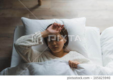 Sleeping face of a woman who feels hard to sleep Sleeping face of a woman who feels hard to sleep 105823940