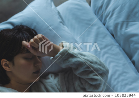 A woman sleeping in bed 105823944