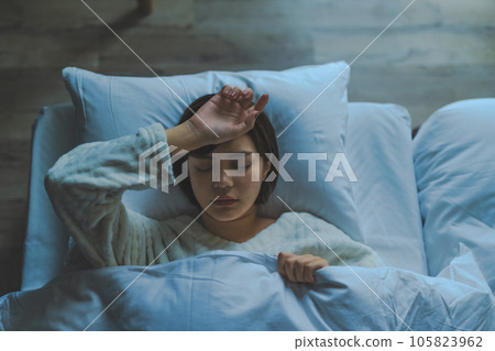 A woman sleeping in bed 105823962