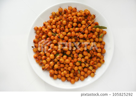 Orange sea buckthorn berries on a white plate. Hippophae. 105825292