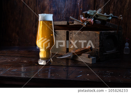 Still life with beer. A glass of light beer in the workshop. Beer in the shop. 105826233