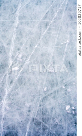 Ice background with marks from skating and hockey, blue texture of rink surface with scratches Ice background with marks from skating and hockey, blue texture of rink surface with scratches 105826717