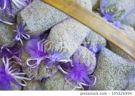 Pouch with lavender in a wooden basket.  105826994