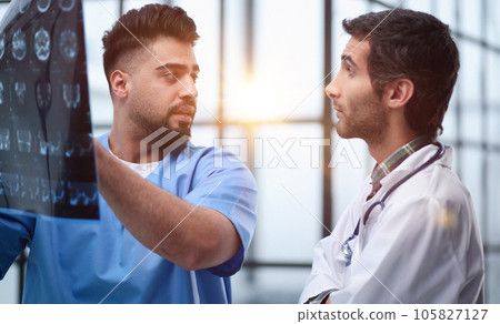 Two male doctors looking at brain x-ray 105827127