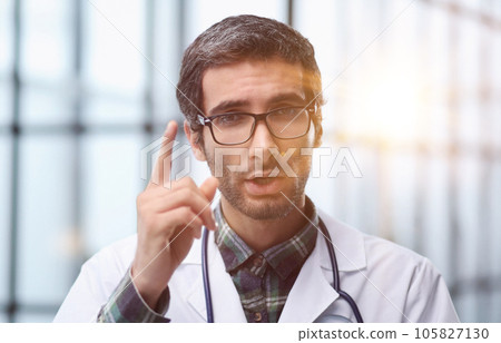 Head shot portrait male doctor talking online with patient, making video call, looking at camera 105827130
