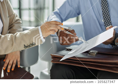 Lawyer, broker or HR manager signing a contract agreement with client or employee. Lawyer, broker or HR manager signing a contract agreement with client or employee. 105827347
