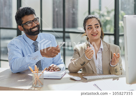 Smart business people working together with laptop while talking in the coworking place. 105827355