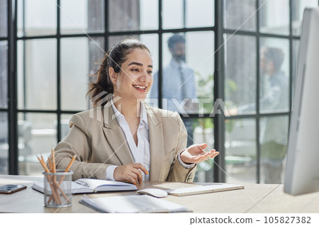 A girl works at a computer in a modern office 105827382