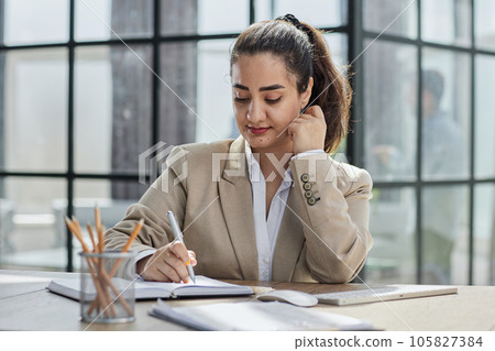 Professional woman at desk, working at computer with email and writing article at digital marketing agency. 105827384