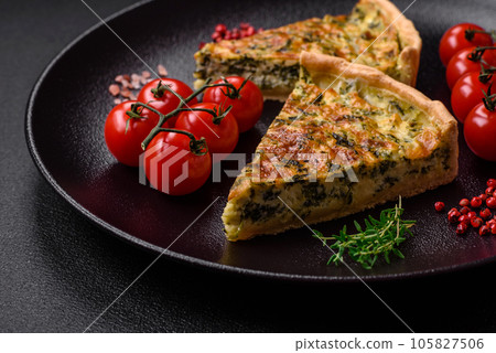 Delicious fresh quiche with broccoli, cheese, spices and herbs cut into pieces Delicious fresh quiche with broccoli, cheese, spices and herbs cut into pieces 105827506