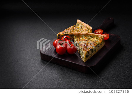 Delicious fresh quiche with broccoli, cheese, spices and herbs cut into pieces Delicious fresh quiche with broccoli, cheese, spices and herbs cut into pieces 105827526