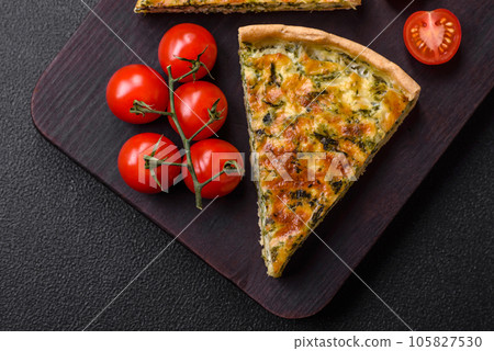 Delicious fresh quiche with broccoli, cheese, spices and herbs cut into pieces Delicious fresh quiche with broccoli, cheese, spices and herbs cut into pieces 105827530