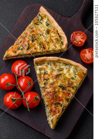 Delicious fresh quiche with broccoli, cheese, spices and herbs cut into pieces 105827531
