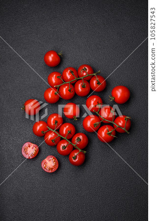 Delicious fresh cherry tomatoes on the branches as an ingredient for cooking a vegetarian dish Delicious fresh cherry tomatoes on the branches as an ingredient for cooking a vegetarian dish 105827543