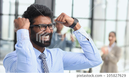 Excited businessman in glasses shouting yes with pleasure and re Excited businessman in glasses shouting yes with pleasure and re 105827629