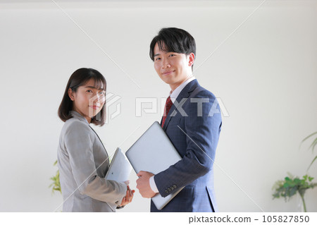 Smiling consultant men and women with devices 1 Smiling consultant men and women with devices 1 105827850