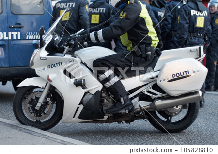 Emergency, road and motorcycle police officer working for protection and peace in an urban town in Denmark. Security, traffic and legal professional or policeman on a motorbike ready for service Emergency, road and motorcycle police officer working for protection and peace in an urban town in Denmark. Security, traffic and legal professional or policeman on a motorbike ready for service 105828810