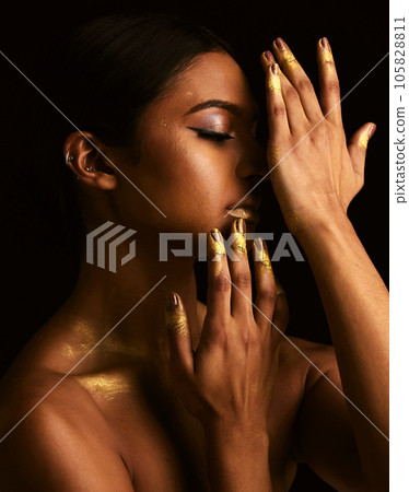 Woman, gold makeup and studio for paint, beauty or body art for creativity, design and black background. Girl, model and skin with metallic texture, pattern or color for cosmetics with dark aesthetic 105828811