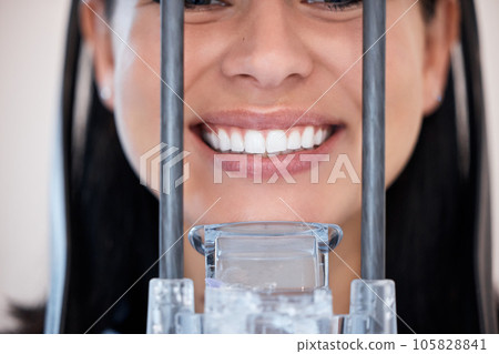 Closeup of a woman getting a digital x-ray scan of her mouth at the dentist. One female only smiling for a dental checkup. Patient taking care of her oral hygiene to maintain healthy teeth and gums Closeup of a woman getting a digital x-ray scan of her mouth at the dentist. One female only smiling for a dental checkup. Patient taking care of her oral hygiene to maintain healthy teeth and gums 105828841