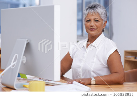 Computer, portrait and mature woman in office for online management, digital planning and working with career mindset. Confident indian person, professional worker or business employee on desktop pc Computer, portrait and mature woman in office for online management, digital planning and working with career mindset. Confident indian person, professional worker or business employee on desktop pc 105828935