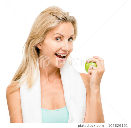 Portrait, fitness and apple with a senior woman in studio isolated on a white background for health. Exercise, diet and lifestyle with a mature female athlete eating fruit for nutrition or weightloss 105829161