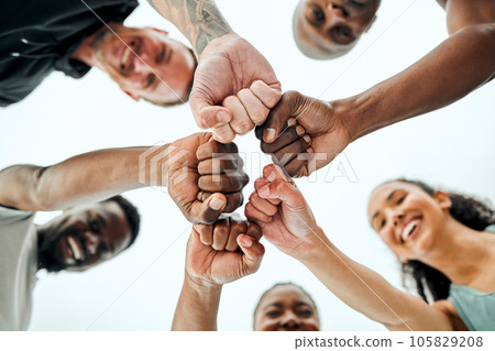 Were here to uplift one another. Shot of a group of friends fist bumping one another before a workout. Were here to uplift one another. Shot of a group of friends fist bumping one another before a workout. 105829208
