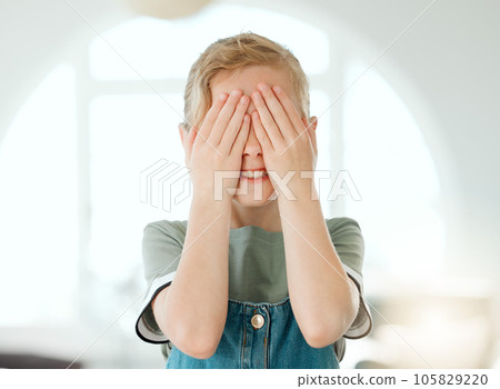 I cant watch. Shot of an adorable little girl standing alone at home and covering her eyes with her hands. I cant watch. Shot of an adorable little girl standing alone at home and covering her eyes with her hands. 105829220