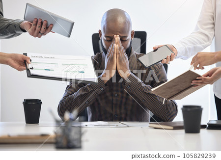 When things get too much, I shut down. Shot of a young businessman looking stressed out in a demanding work environment. When things get too much, I shut down. Shot of a young businessman looking stressed out in a demanding work environment. 105829239