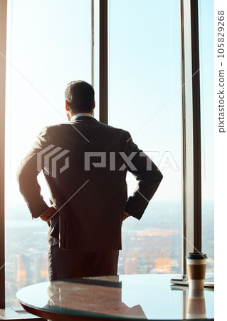 Building window, business man and thinking of ideas, plan or vision with cityscape. Professional male executive with hands on hips for inspiration, dream and corporate development from behind 105829268