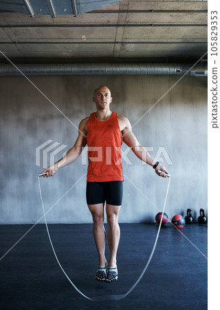 Keep it going. Fitness, jump rope and portrait of man doing gym training, cardio endurance challenge or exercise performance. Skipping, active lifestyle and male sports person doing jumping workout. 105829353
