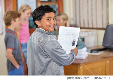 Portrait, child and smile of student with paper in classroom for assignment or class test. Happiness, education and Indian kid with document for studying, learning and assessment in primary school. Portrait, child and smile of student with paper in classroom for assignment or class test. Happiness, education and Indian kid with document for studying, learning and assessment in primary school. 105829405