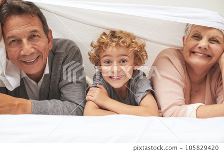 Portrait, grandparents or happy boy in bedroom to relax together for bonding in Australia with love at home. Morning, faces or grandmother with funny cute kid or old man to enjoy quality time on bed 105829420