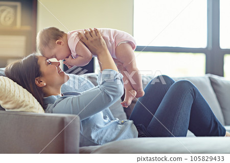 Mother, bonding or baby girl in airplane game on house living room, relax nursery or family home sofa. Smile, happy or flying infant with playing mom in comic, funny or silly kids activity in trust 105829433