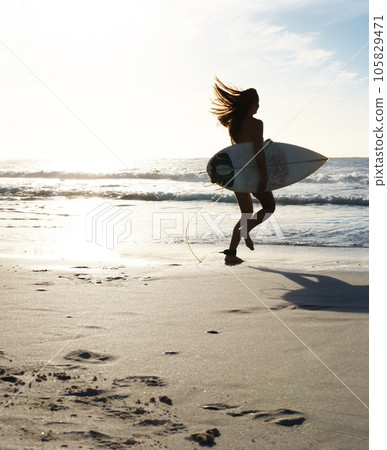 Silhouette, woman surfer running on beach sand and sea, exercise outdoor with surfboard to surf in nature. Sports, shadow and sun with female person run to ocean waves for surfing and mockup space Silhouette, woman surfer running on beach sand and sea, exercise outdoor with surfboard to surf in nature. Sports, shadow and sun with female person run to ocean waves for surfing and mockup space 105829471