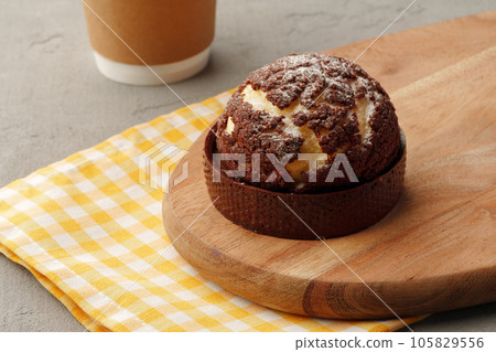 Choux pastry with cracked chocolate crumble topping Choux pastry with cracked chocolate crumble topping 105829556