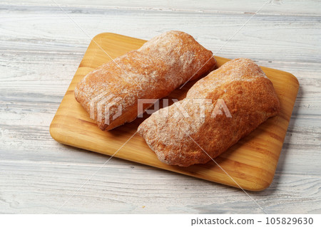 Two bread buns on wooden board close up Two bread buns on wooden board close up 105829630