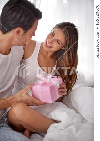 Man giving woman gift, love and happy with partnership, relationship and celebration on Valentines day date. Couple smile with present, luxury and commitment, gratitude and celebrate holiday 105829676