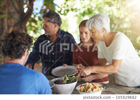 Food, party and salad with family at lunch and serving for health, bonding and celebration. Vacation, social and event with parents and children eating together for dining, generations and wellness 105829682