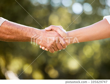 We can do this together. Shot of two unrecognisable men shaking hands outdoors. 105829747
