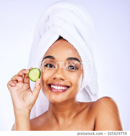 Skincare, cucumber and portrait of Indian woman in studio happy with detox, wellness or hydration treatment on grey background. Fruit, beauty and face of female smile for natural, vegan or diy facial Skincare, cucumber and portrait of Indian woman in studio happy with detox, wellness or hydration treatment on grey background. Fruit, beauty and face of female smile for natural, vegan or diy facial 105829759