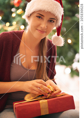 Portrait, woman and gift on a floor for wrapping, decoration and celebration in living room, happy and content. Face, girl and gift box opening during festive holiday, vacation and tradition at home Portrait, woman and gift on a floor for wrapping, decoration and celebration in living room, happy and content. Face, girl and gift box opening during festive holiday, vacation and tradition at home 105830028