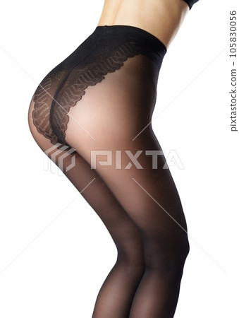 Legs of a woman in black capron tights on white background 105830056