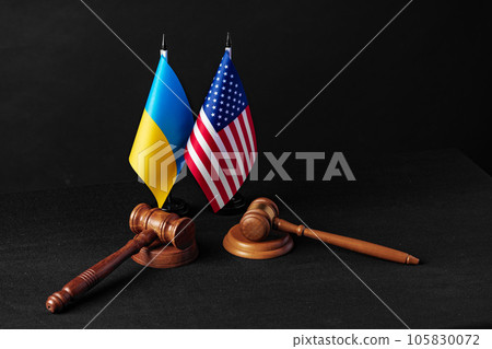 Two judge's gavels with USA flag and flag of Ukraine on black background Two judge's gavels with USA flag and flag of Ukraine on black background 105830072