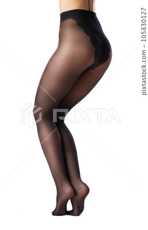 Legs of a woman in black capron tights on white background Legs of a woman in black capron tights on white background 105830127
