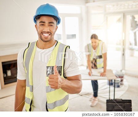 Portrait of man, construction and home renovation with thumbs up, helmet and smile in apartment. Yes, positive mindset and diy renovations, happy handyman in safety and building project in new house. 105830167
